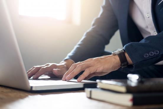 Man typing at a laptop