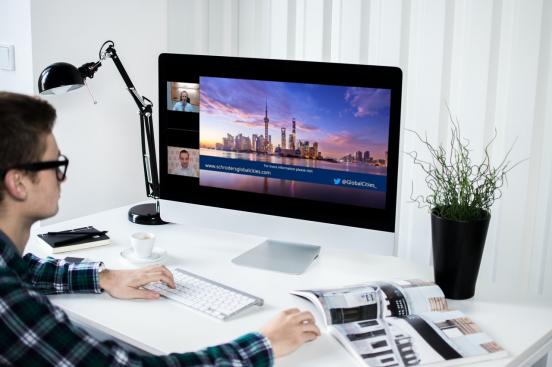 person watching webinar on monitor