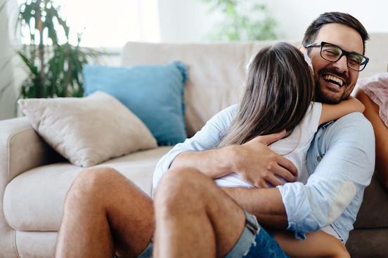 Father and young daughter hugging