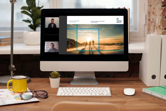 Image of a screen showing two men presenting