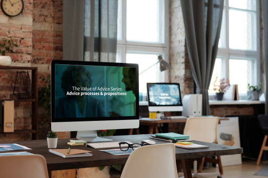 A computer screen in an office displays a screen saying "The Value of Advice series advice processes and propositions"