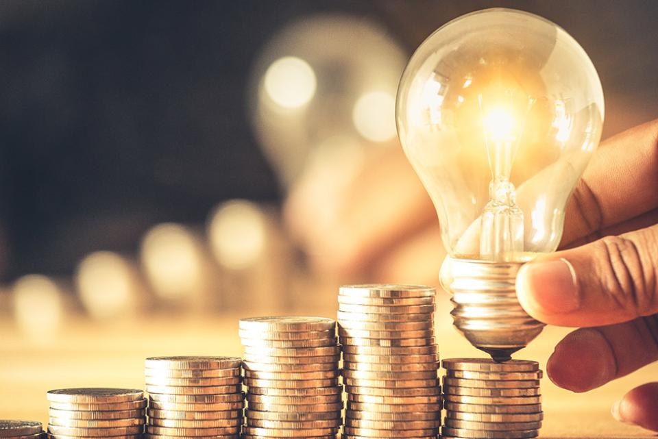 image of a lightbulb on a stack of coins