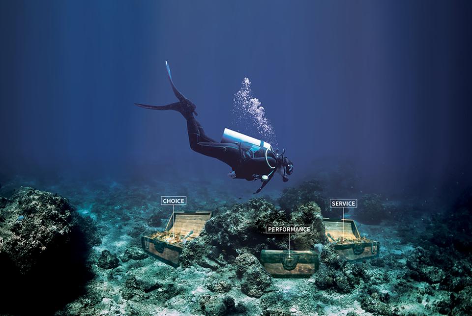 A person in diving gear diving for treasure chests