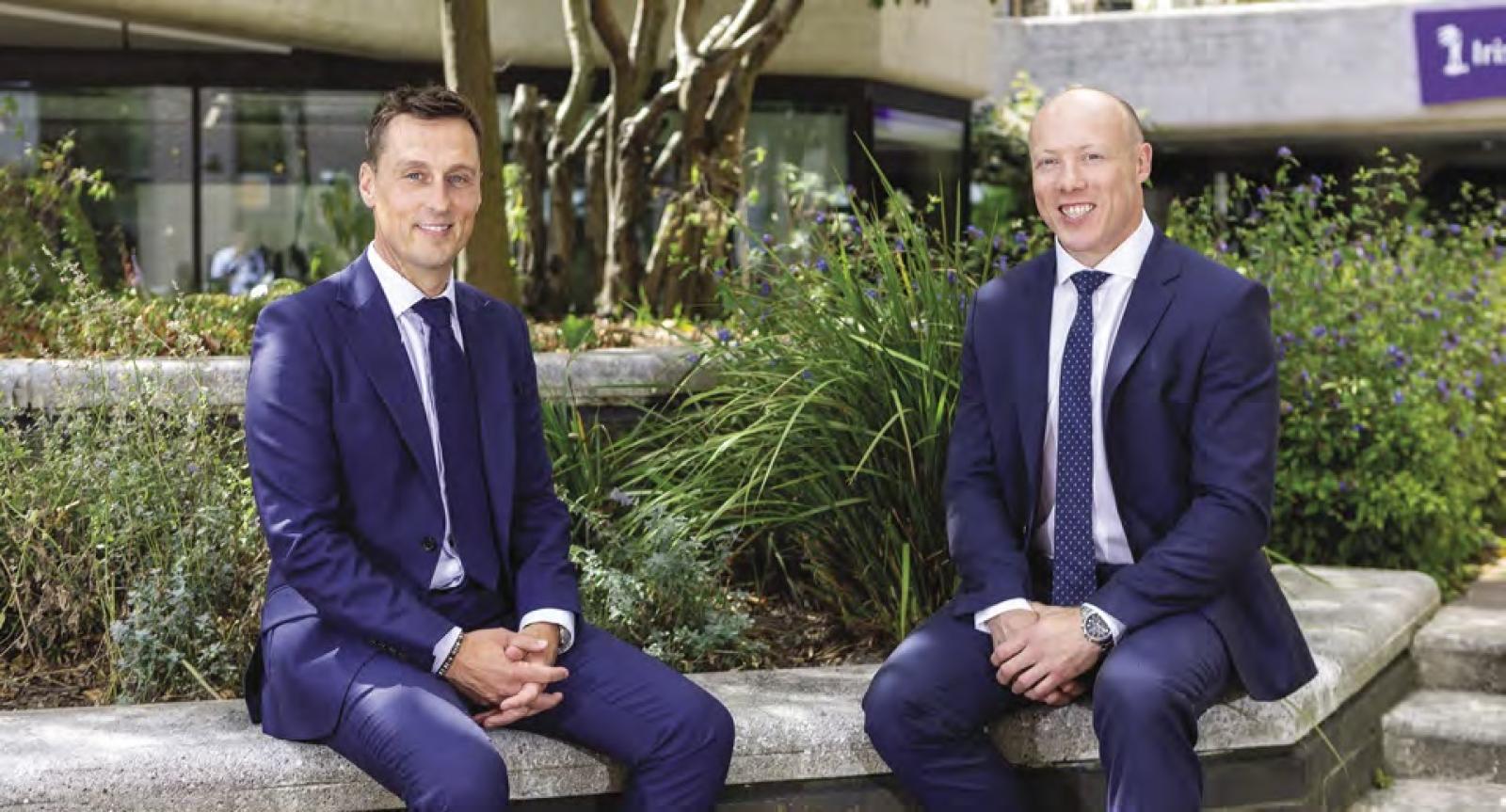 Patrick Ryan and Anthony Kavanagh of Irish Life sit on a wall in an office garden