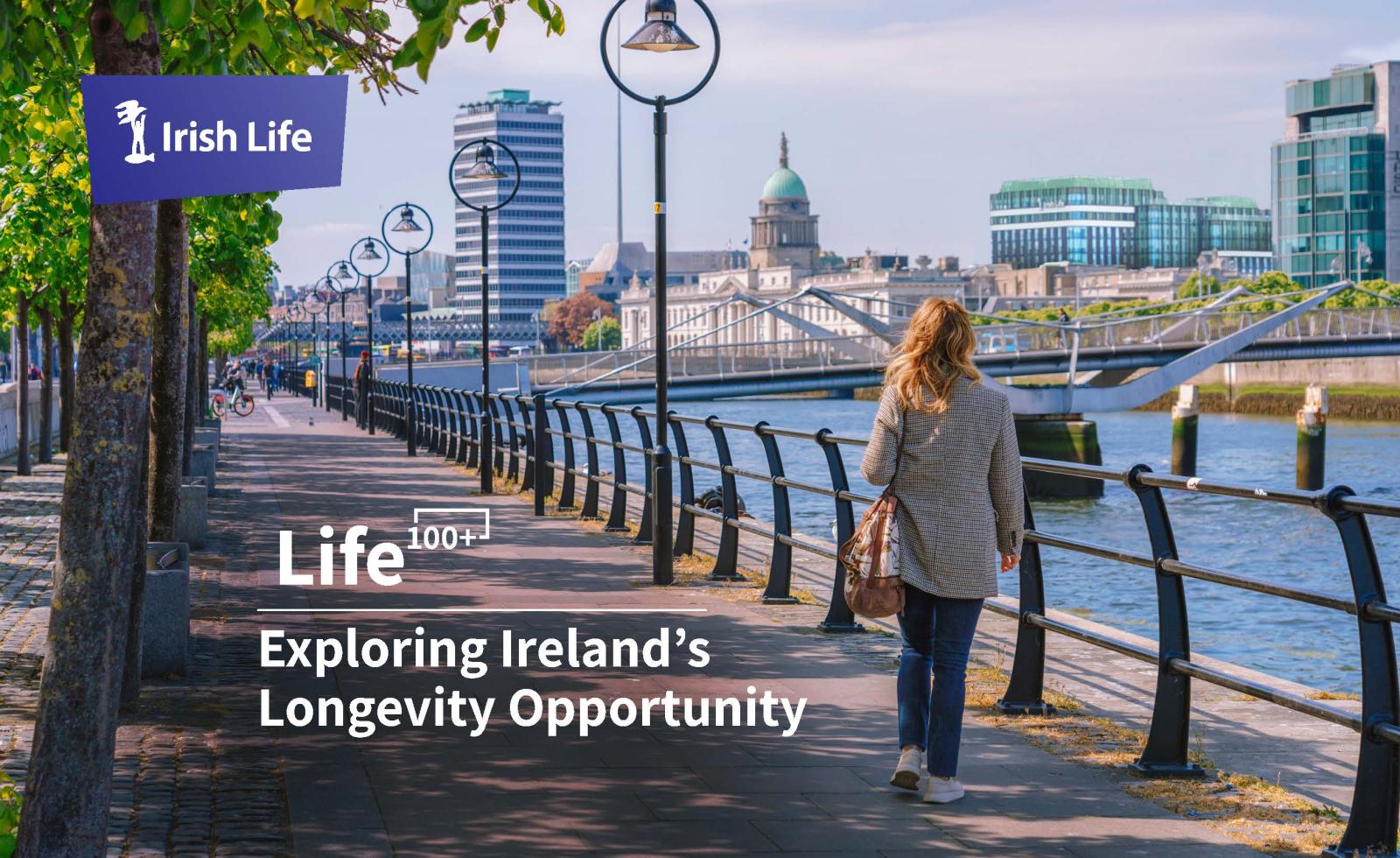 An image of a woman with blond hair in a checked jacket, jeans and white trainers, carrying a brown shoulder bag walking west along City Quay in Dublin on a sunny day